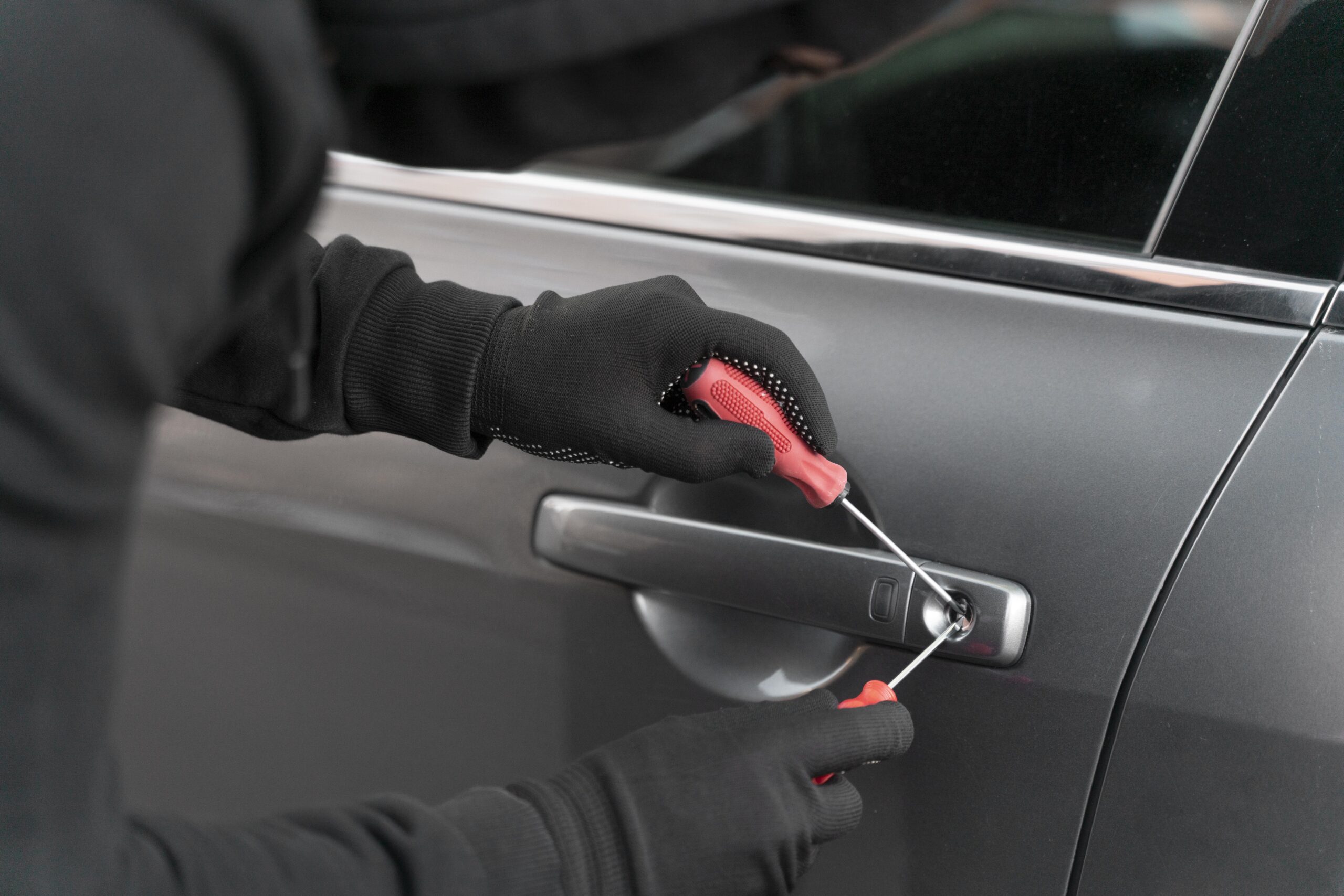 close-up-man-trying-break-into-car (1)
